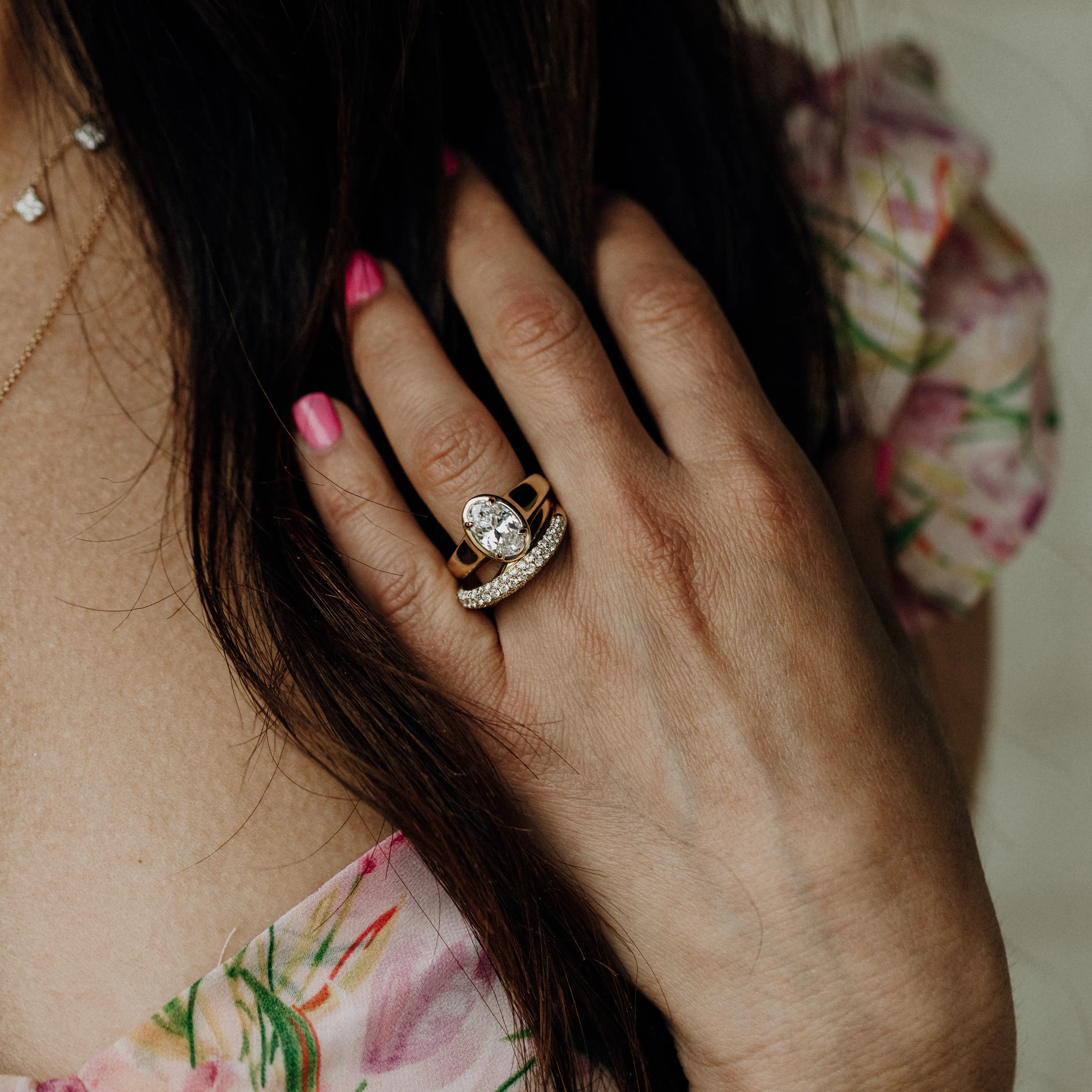 Three elegant diamond rings on a hand with red nails, showcasing fine jewelry from Koerbers Fine Jewelry in New Albany.