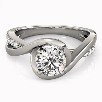 Elegant bypass engagement ring featuring a round diamond center stone and accent diamonds on a sleek band. Click to view.