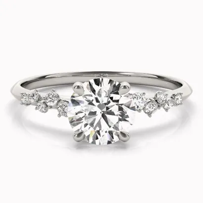 Elegant diamond engagement ring with a central round stone and smaller diamonds on the band.