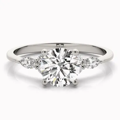 Three-stone diamond engagement ring featuring a central round diamond and two side stones.