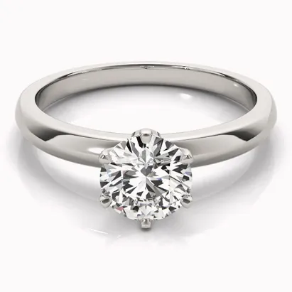 Solitaire engagement ring with a round diamond set in a polished white gold band.