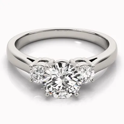 Three stone diamond engagement ring with a central round diamond and two smaller side diamonds.