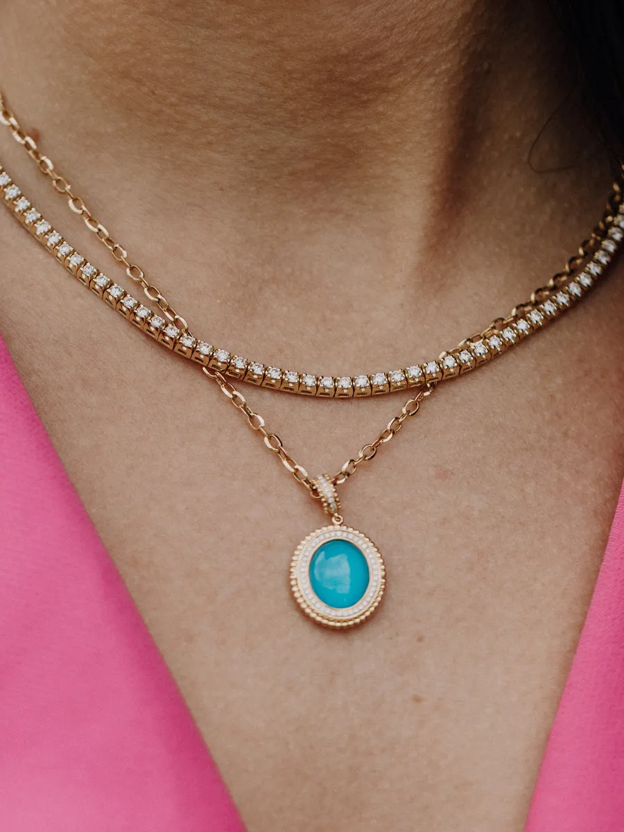 Gold layered necklaces featuring a turquoise pendant, perfect for adding elegance.