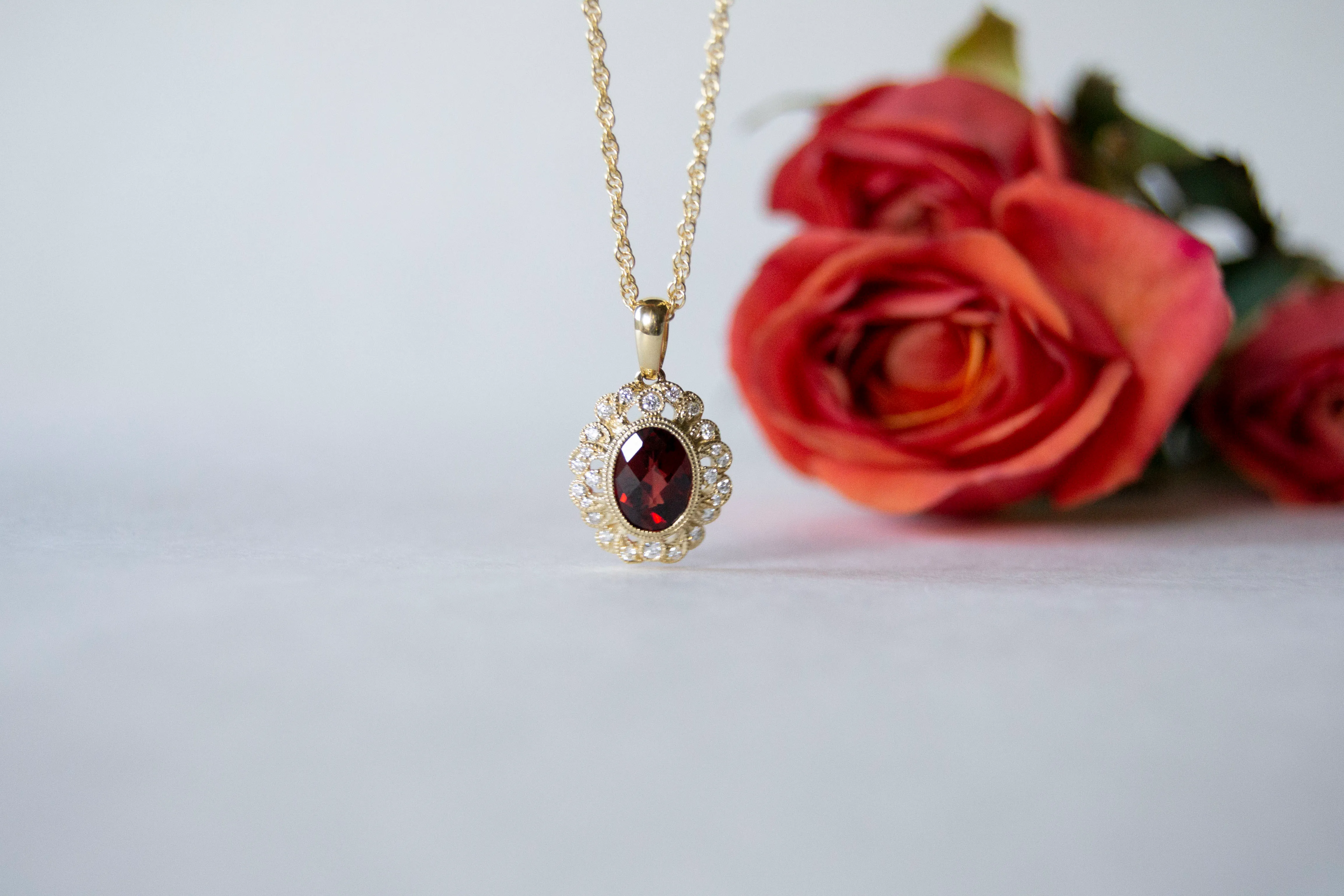 Yellow gold garnet diamond pendant