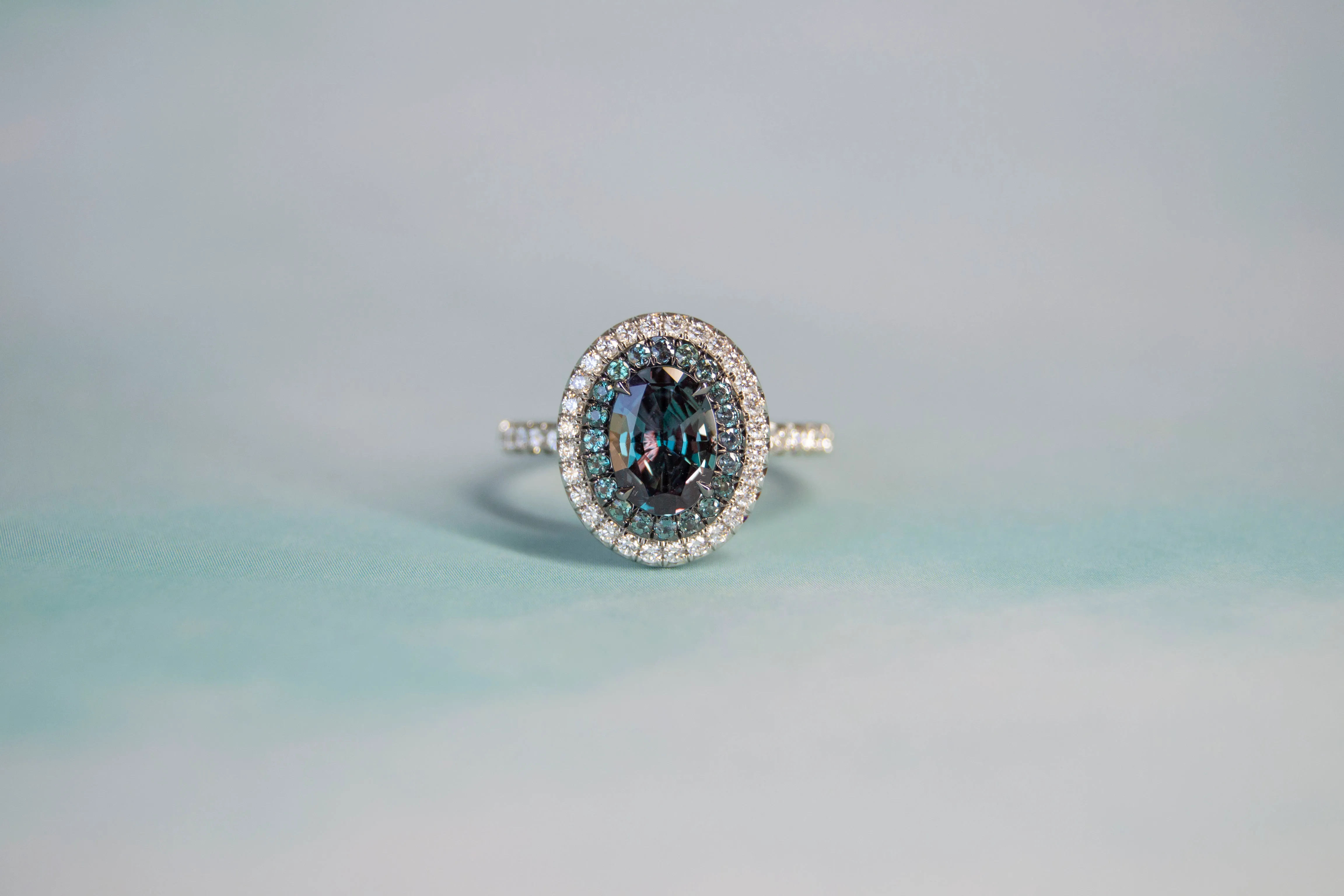 Alexandrite Ring Alexandrite's colors transform and change like the sky at sunset. Encircled by diamonds, this museum level work of art is brought to you by Omi Privé. The Diamond Center Claremont, CA