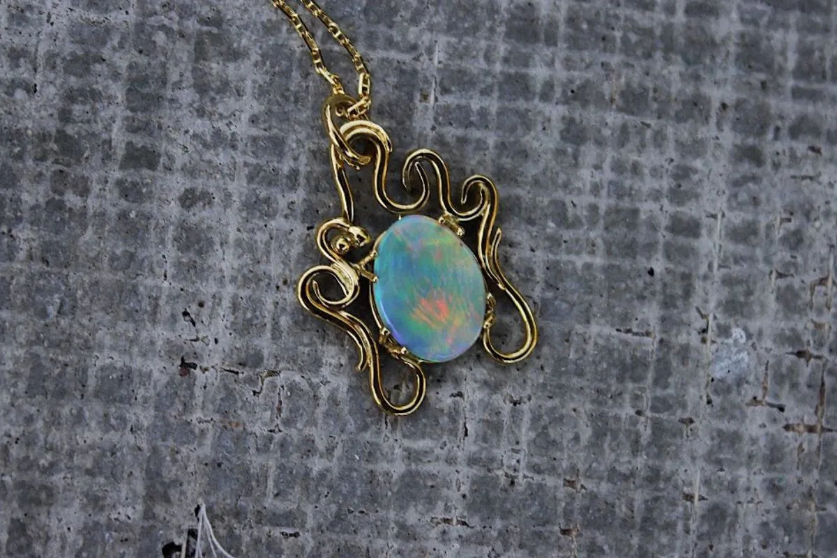 Australian Lightning Ridge Semi-Black Opal Pendant with Yellow Gold swirls at The Diamond Center Claremont, CA