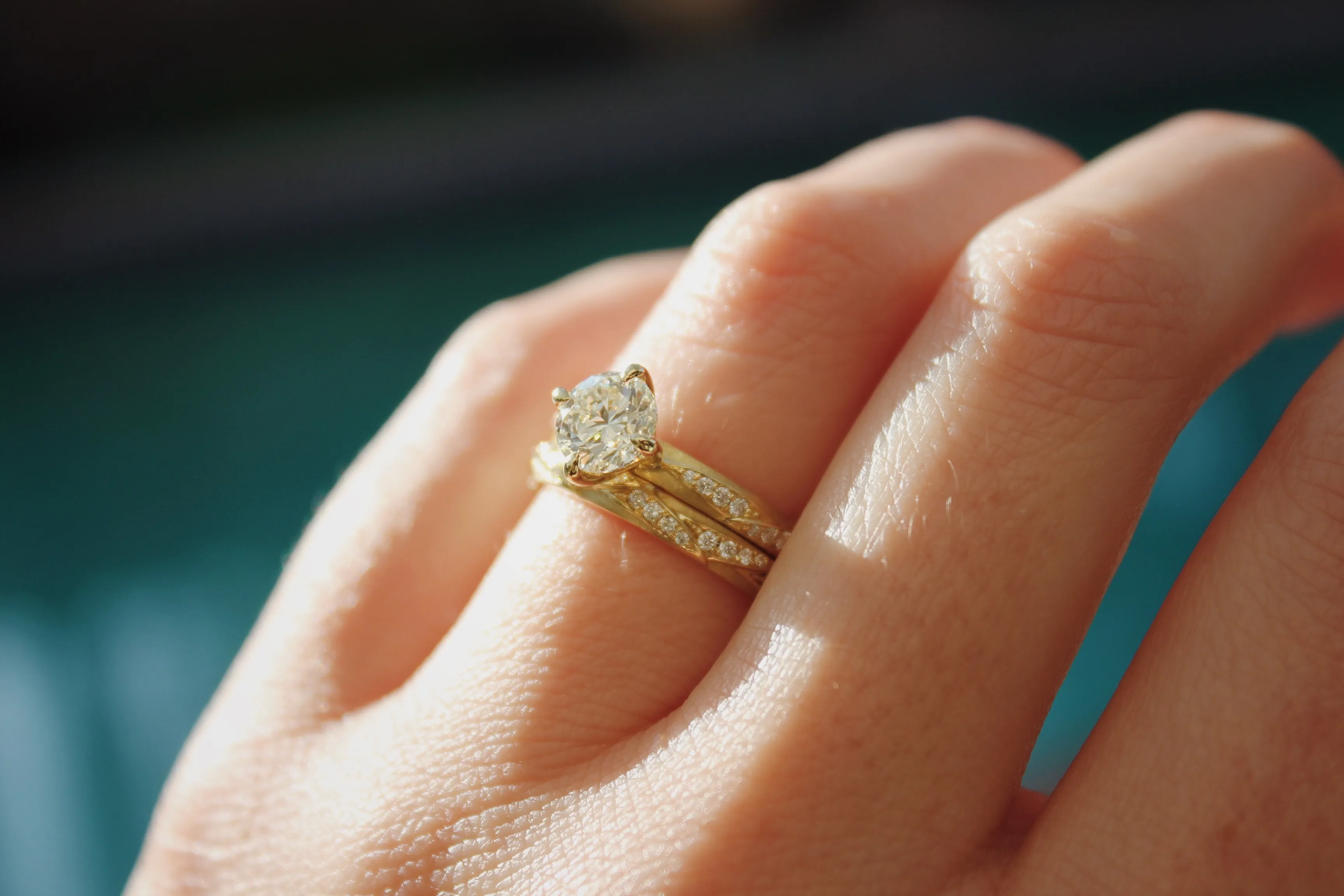 Alternating Ray Yellow Gold Bridal Set In this wedding set, the north-south east-west setting highlights the glowing center diamond. A sunshine yellow gold and matching diamond pattern on the bands makes these rings extra special! The Diamond Center Claremont, CA
