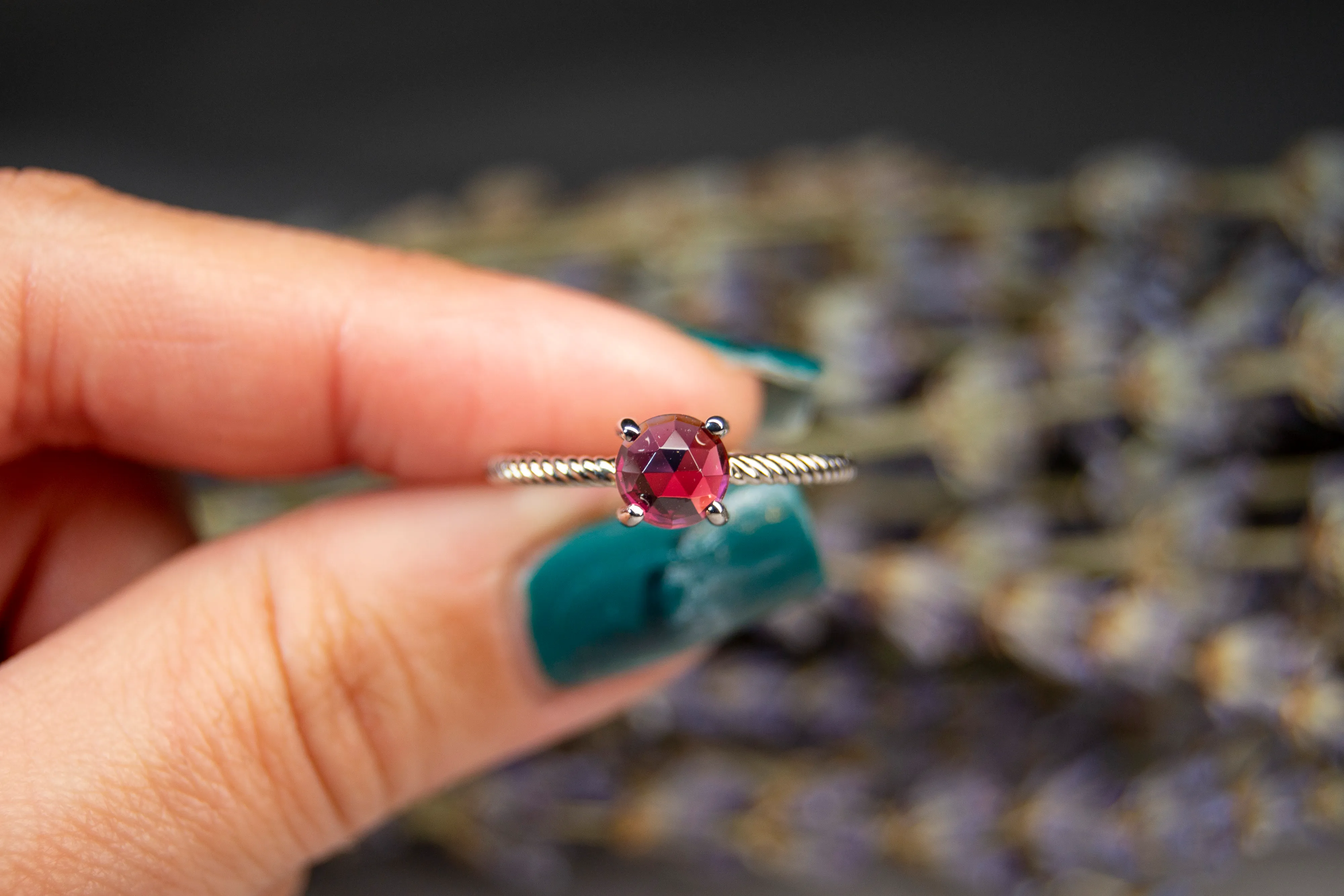 garnet ring with a twisted rose gold band january birthstone
