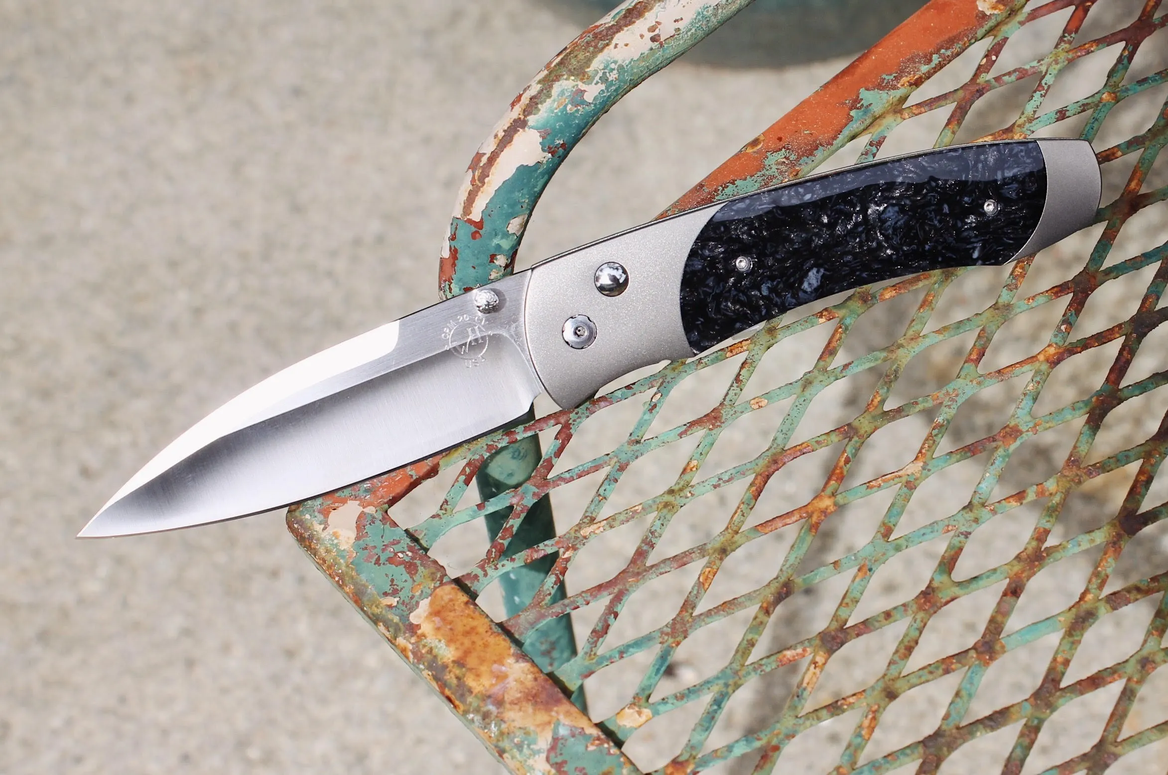 Stainless Steel and Titanium Kirinite Knife Sleek, sturdy, and masterfully crafted, this blade is forged with aerospace-grade titanium that contrasts with the intricate pattern on the hilt. Its timeless design and reliable build will serve you for a lifetime. The Diamond Center Claremont, CA