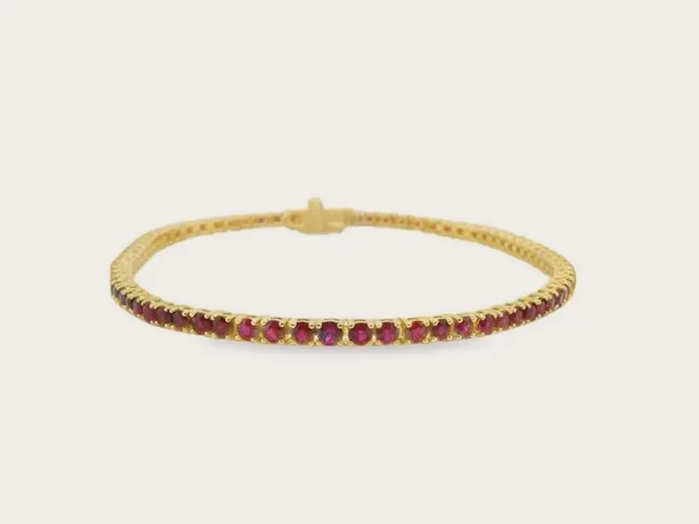 Gold bracelet with red gemstones on a white background. Click to explore bracelets.