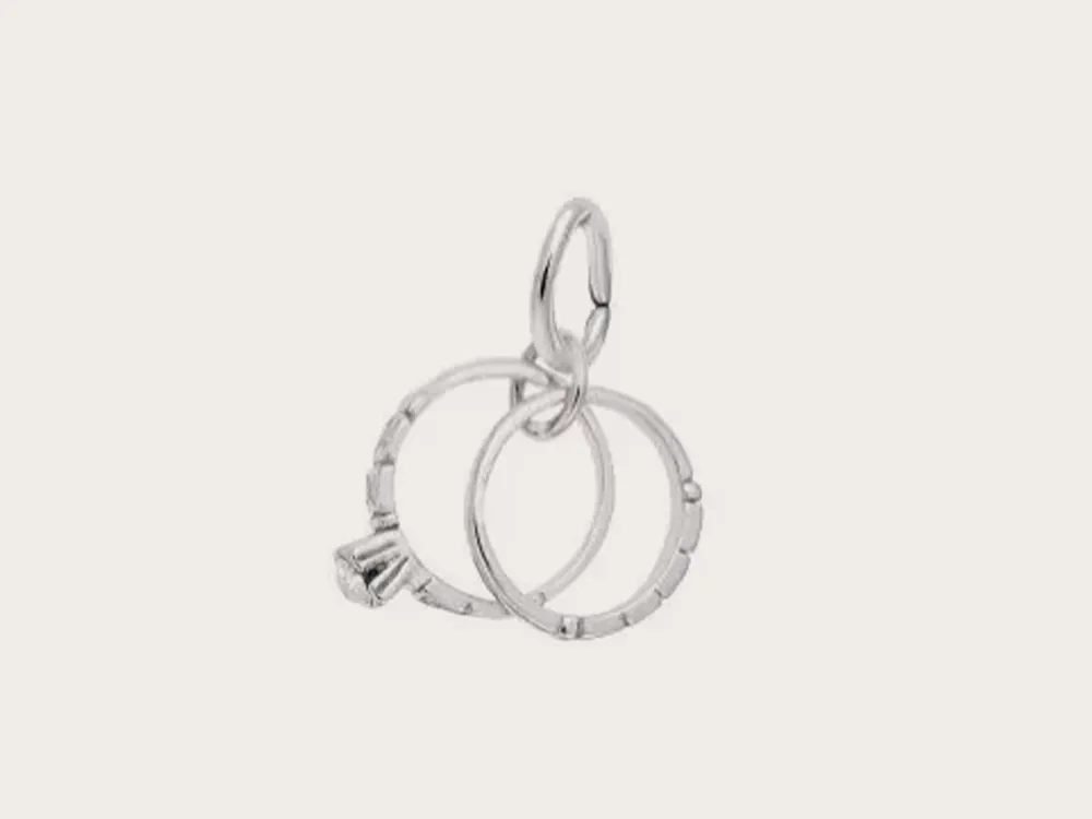 Silver charm with two interlocking rings and a small crown detail. Click to explore charms.