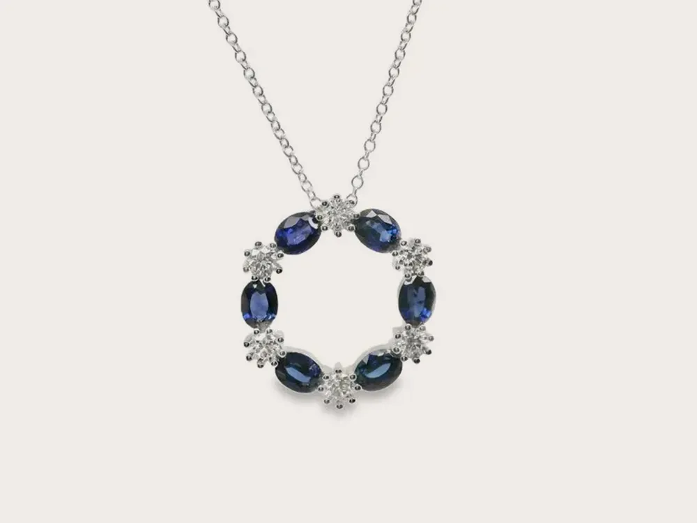Blue gemstone and diamond circle pendant necklace on a silver chain. Click to view Necklaces & Pendants.