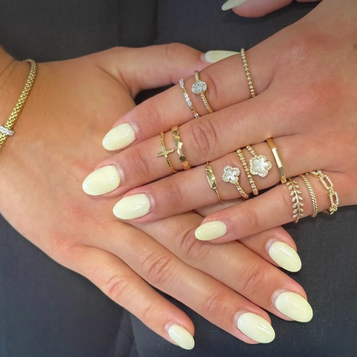Two elegant gold and silver bracelets with diamond accents on a light background.