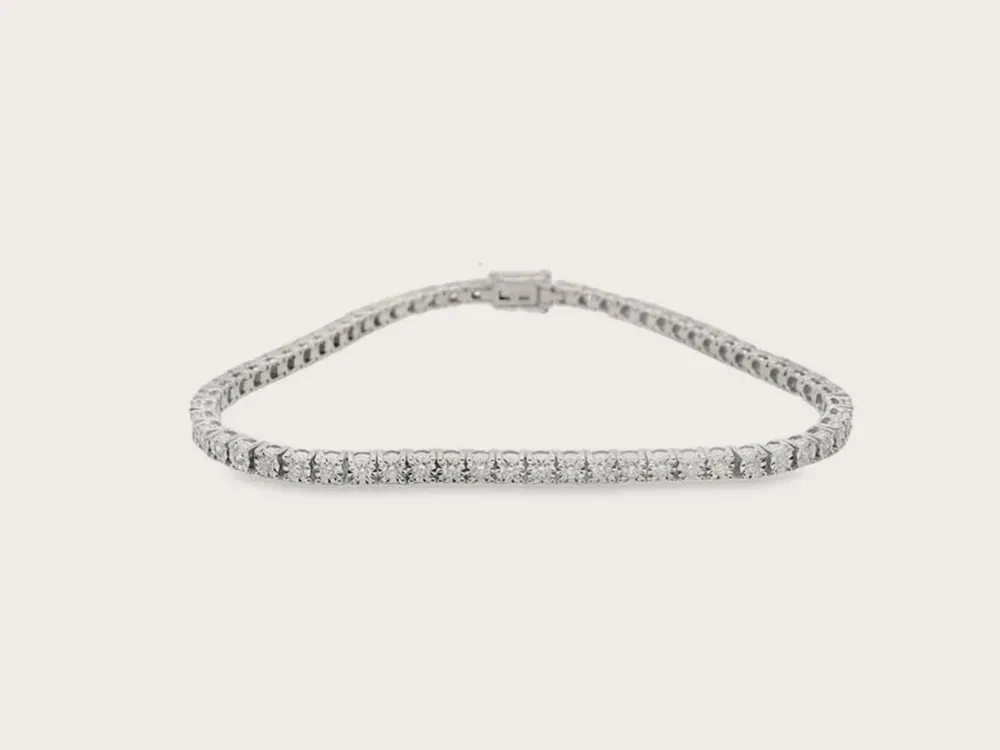 Diamond tennis bracelet on a white background. Click to shop bracelets.