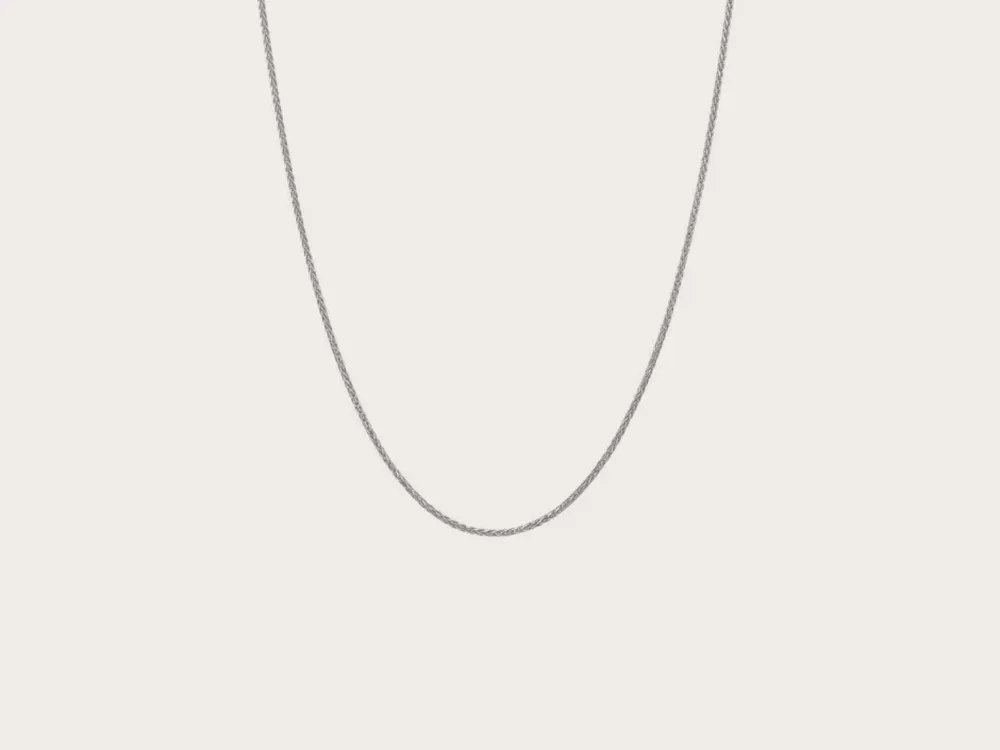 Silver chain necklace on a plain background. Click to shop chains.