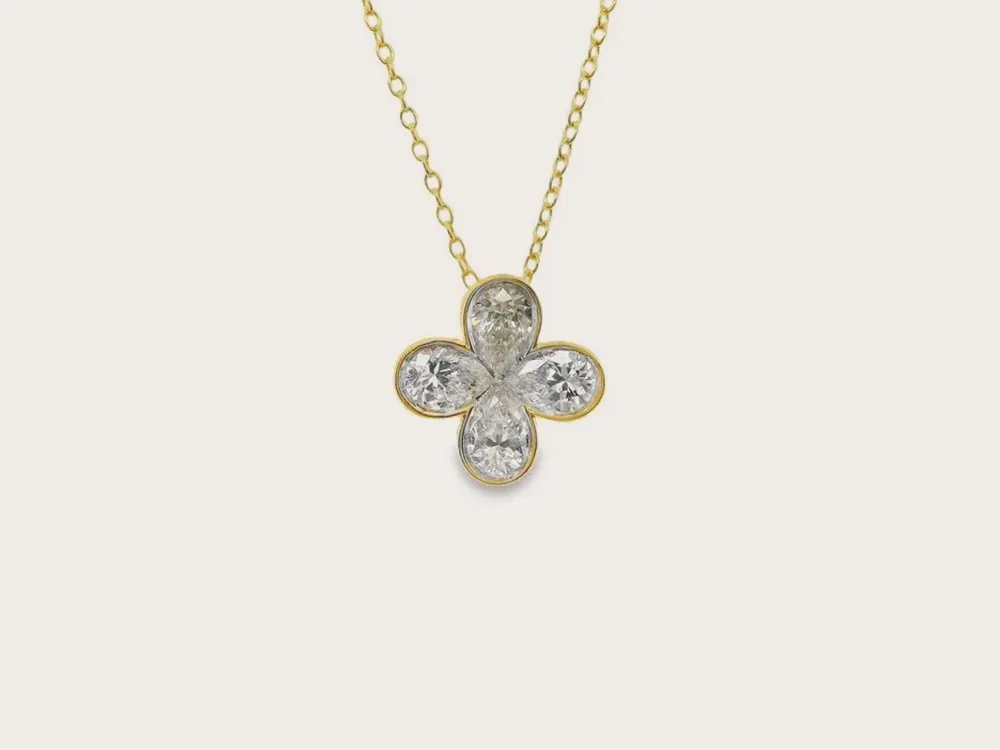 Gold chain necklace with a diamond flower pendant. Click to shop necklaces and pendants.