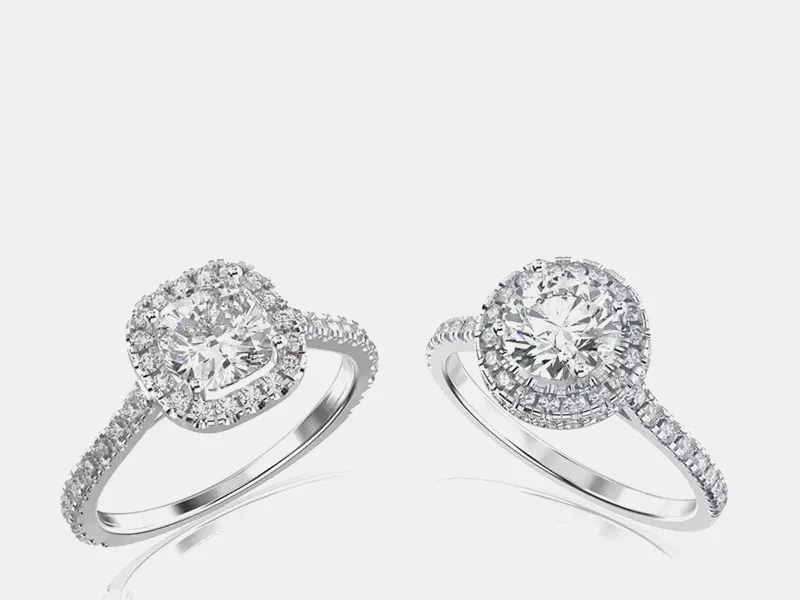 Two elegant engagement rings featuring sparkling diamonds set in white gold, showcasing different styles. Shop now at Lester Mar