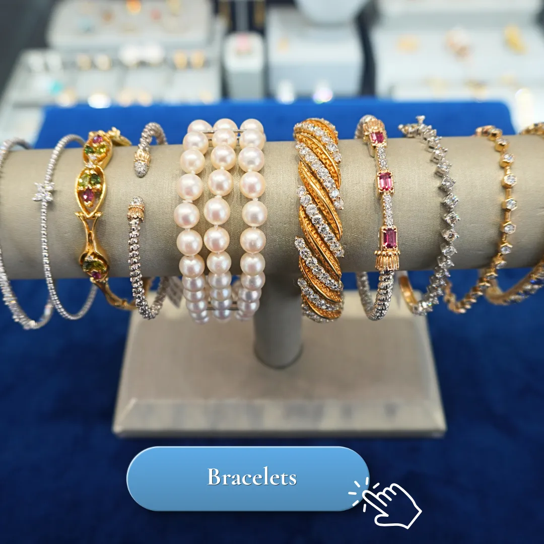 A display of various elegant bracelets, including pearl and gemstone designs, on a blue background.