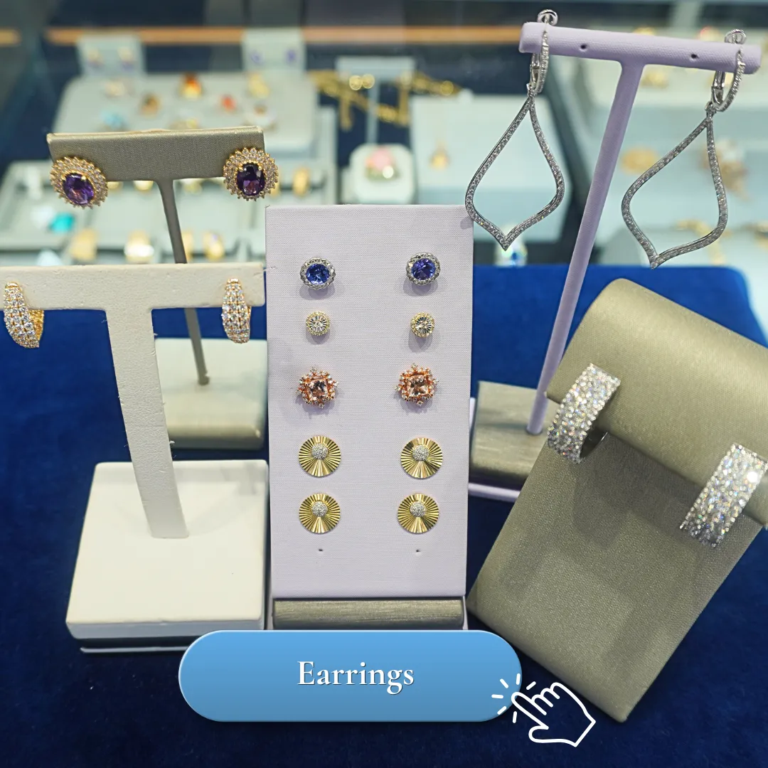 Elegant display of various earrings on stands at Lumina Gem jewelry store.