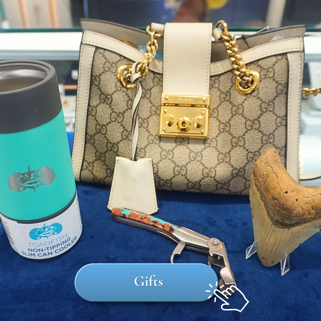 A designer handbag, can cooler, corkscrew, and shark tooth displayed on a blue surface.