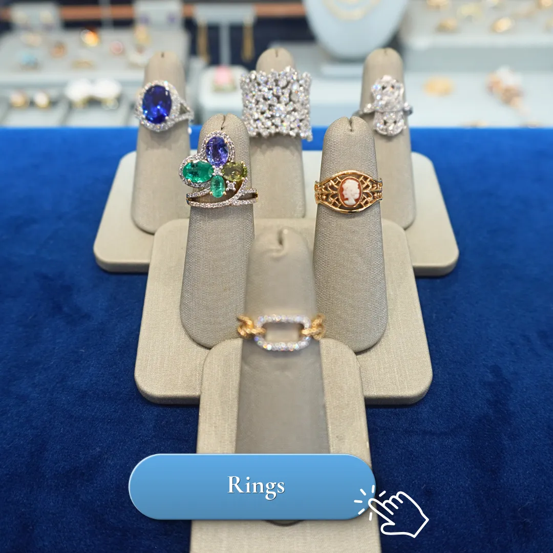 Elegant rings displayed on stands in a jewelry store setting.