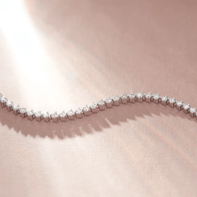 Elegant diamond bracelet displayed on a soft surface, showcasing its sparkle and design.