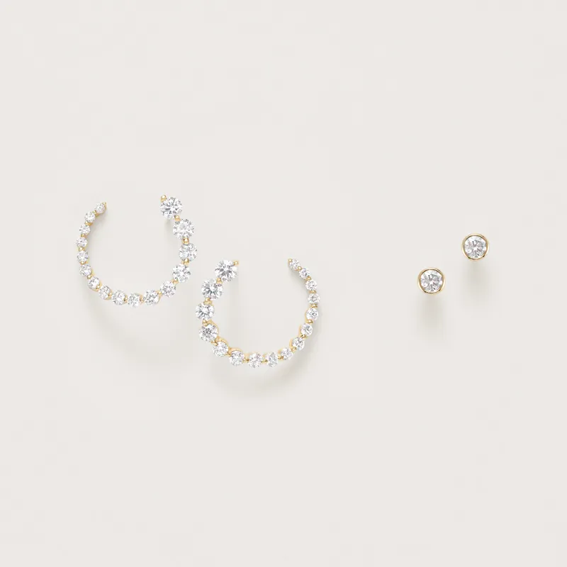Elegant gold hoop earrings with sparkling stones and matching stud earrings, perfect for any occasion.