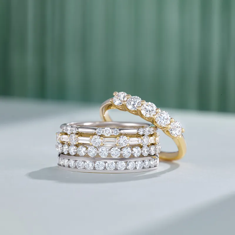 Three elegant diamond rings stacked together, showcasing a mix of gold and silver settings.