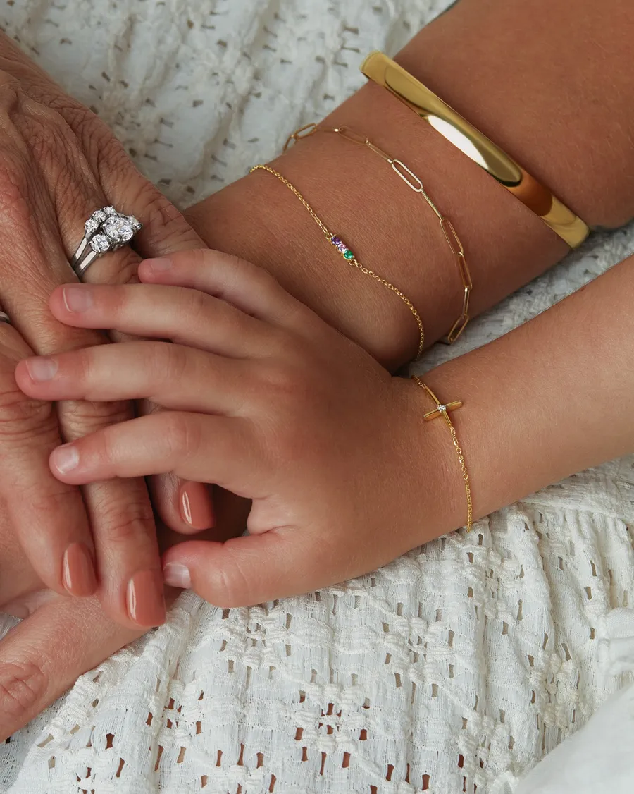 A close-up of hands adorned with various jewelry pieces, showcasing a mix of rings and bracelets.