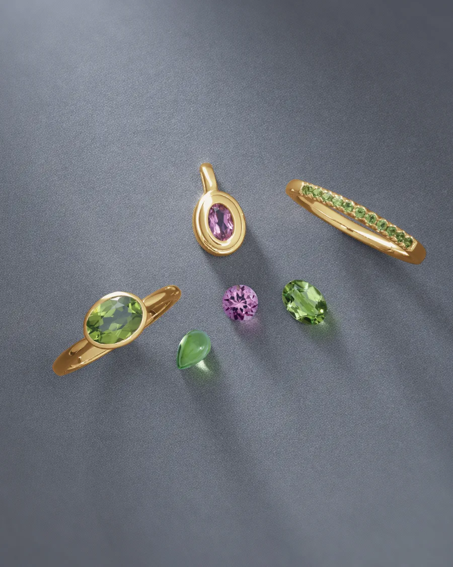 Colorful birthstone jewelry featuring gold rings and gemstones.