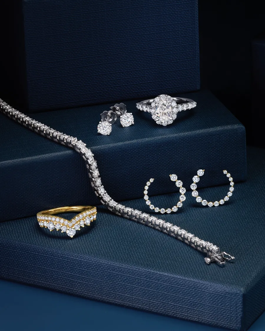 Elegant display of diamond jewelry including rings, earrings, and a bracelet.