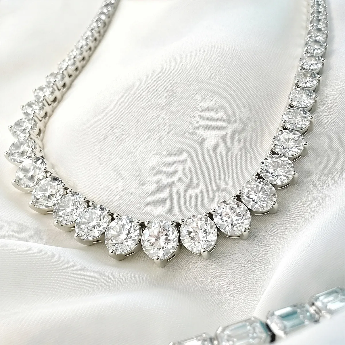 Elegant pearl pendant necklace on a silver chain displayed in a jewelry box.