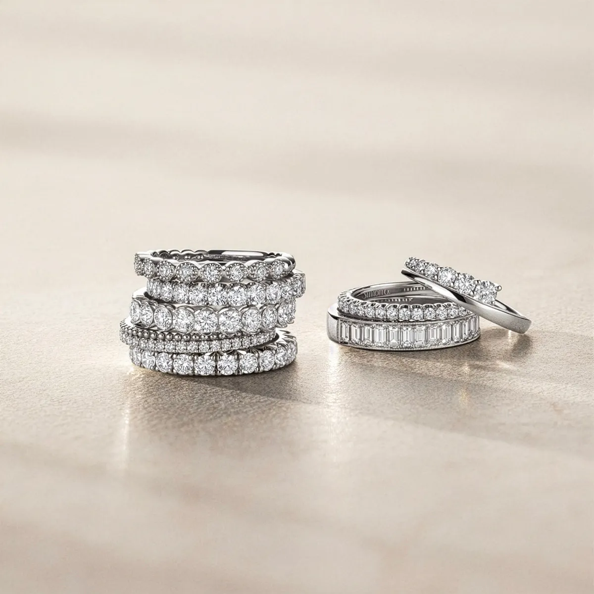 A collection of elegant diamond wedding bands displayed on a neutral background.