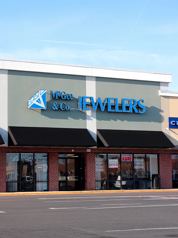 Storefront of McGee & Co. Jewelers with blue signage and large windows.