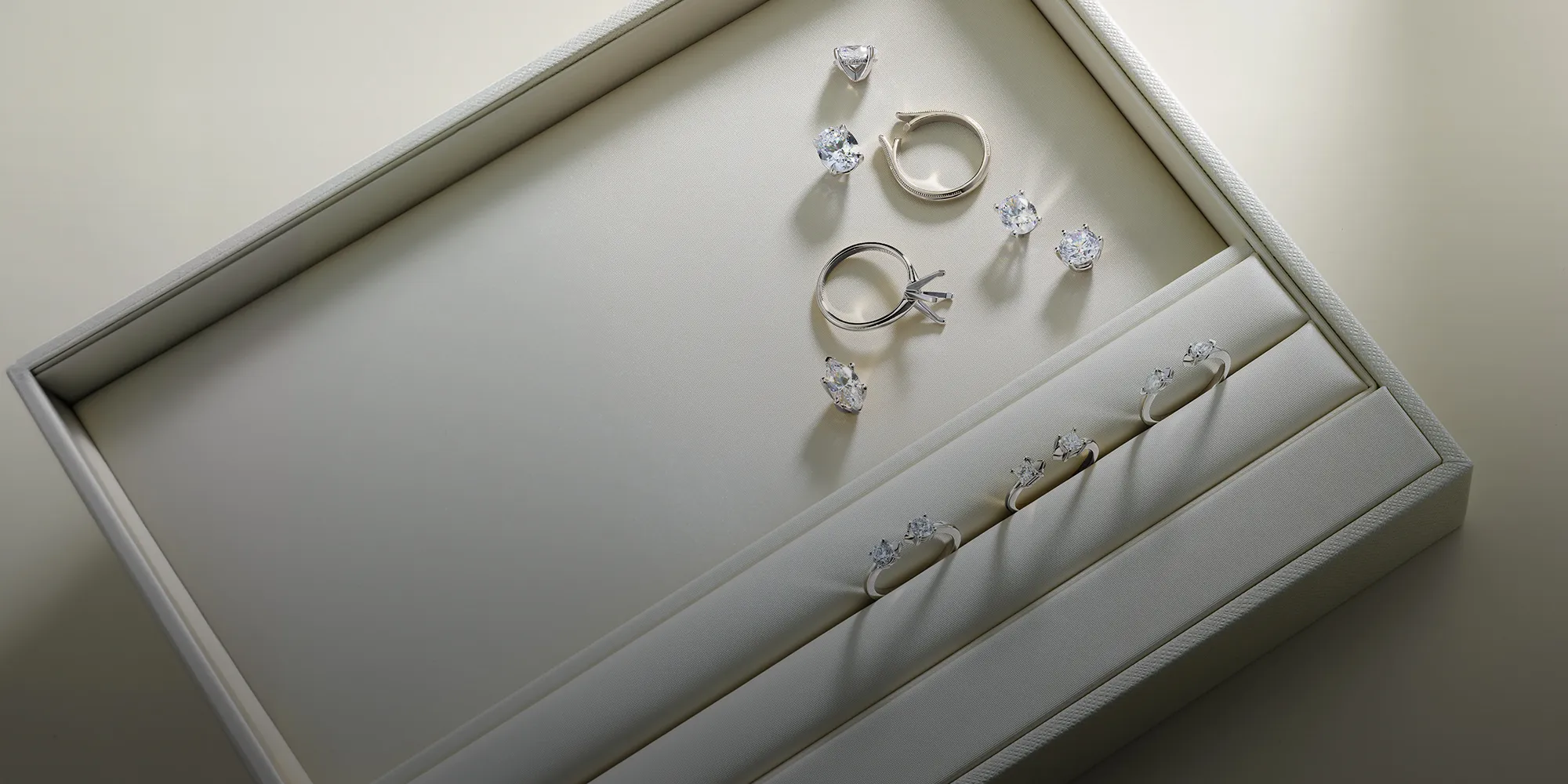 Jewelry box with diamond rings and loose stones. Book an appointment at McGee & Company Fine Jewelers.