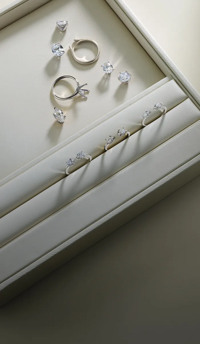 Jewelry box with diamond rings and loose stones. Book an appointment at McGee & Company Fine Jewelers.