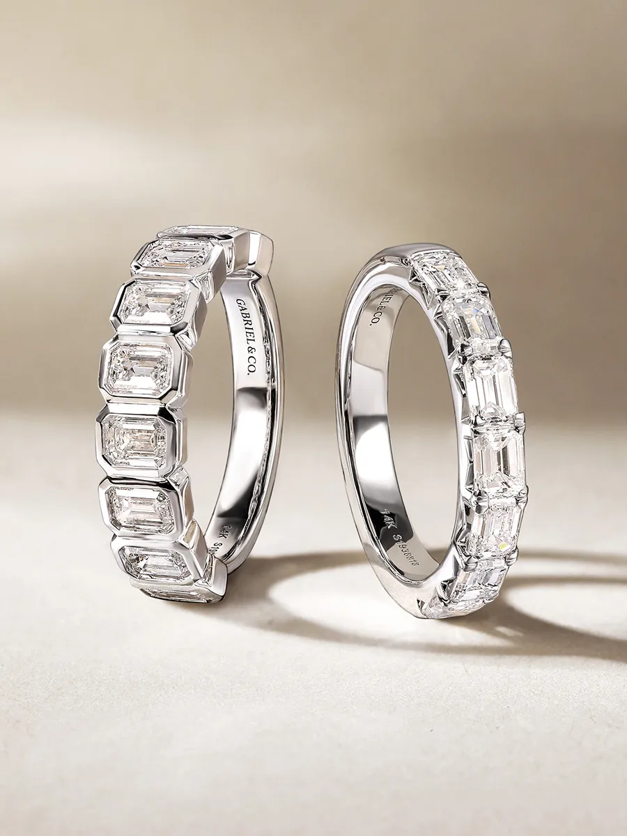Two silver rings with rectangular diamonds displayed on a neutral background.