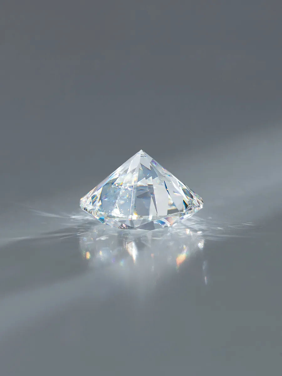 A sparkling diamond on a reflective surface at McGee & Company Fine Jewelers, Greenwood.