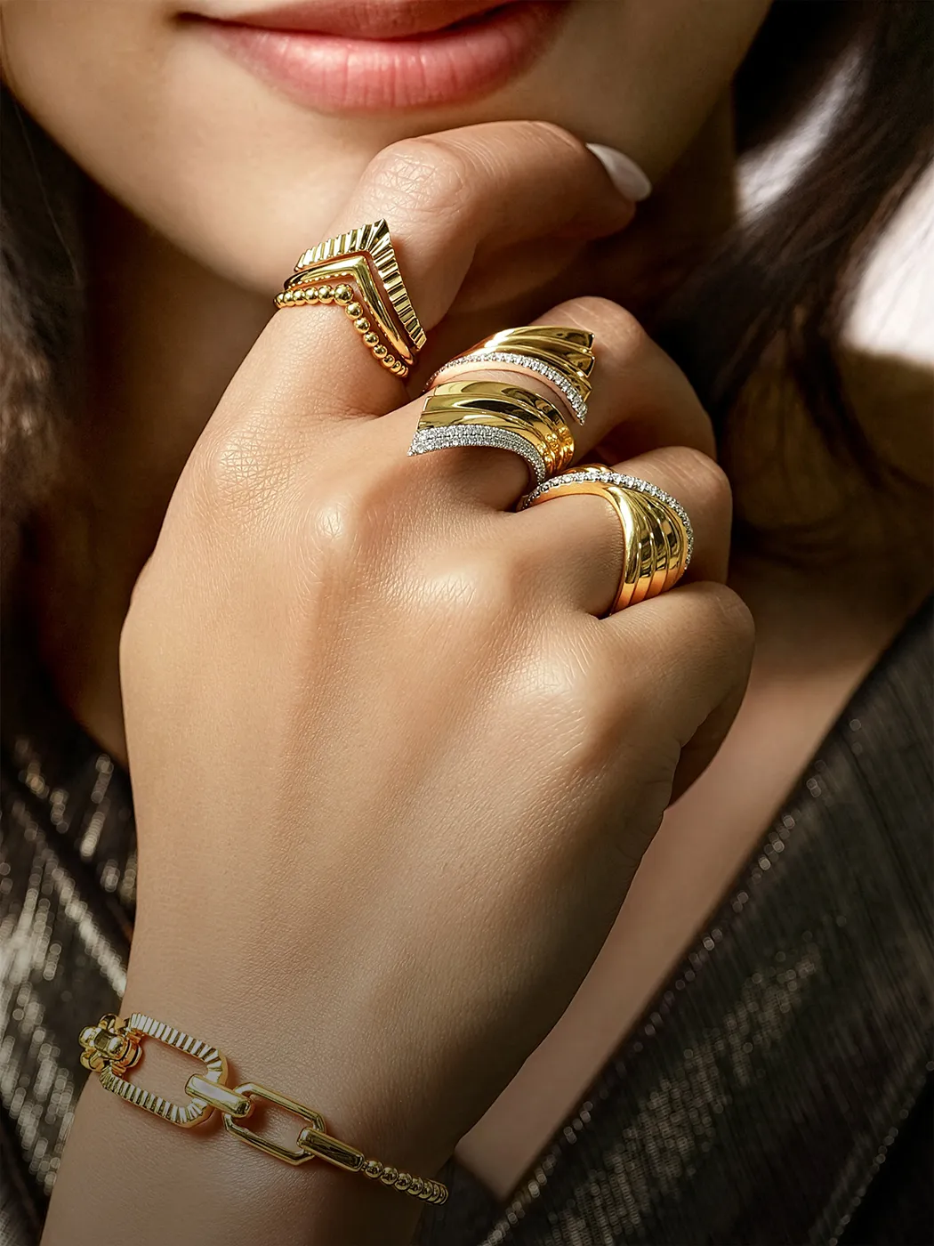 Fashion rings on a hand with gold bracelet at McGee & Company Fine Jewelers, Greenwood, Indiana.