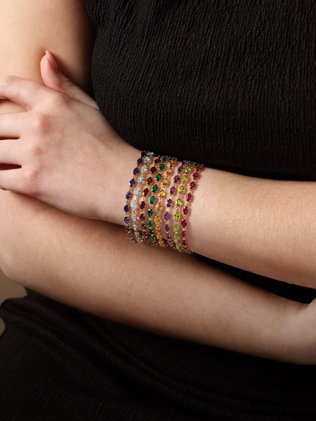 Colorful gemstone bracelets on a woman's wrist. Learn more about gemstones at McGee & Company.