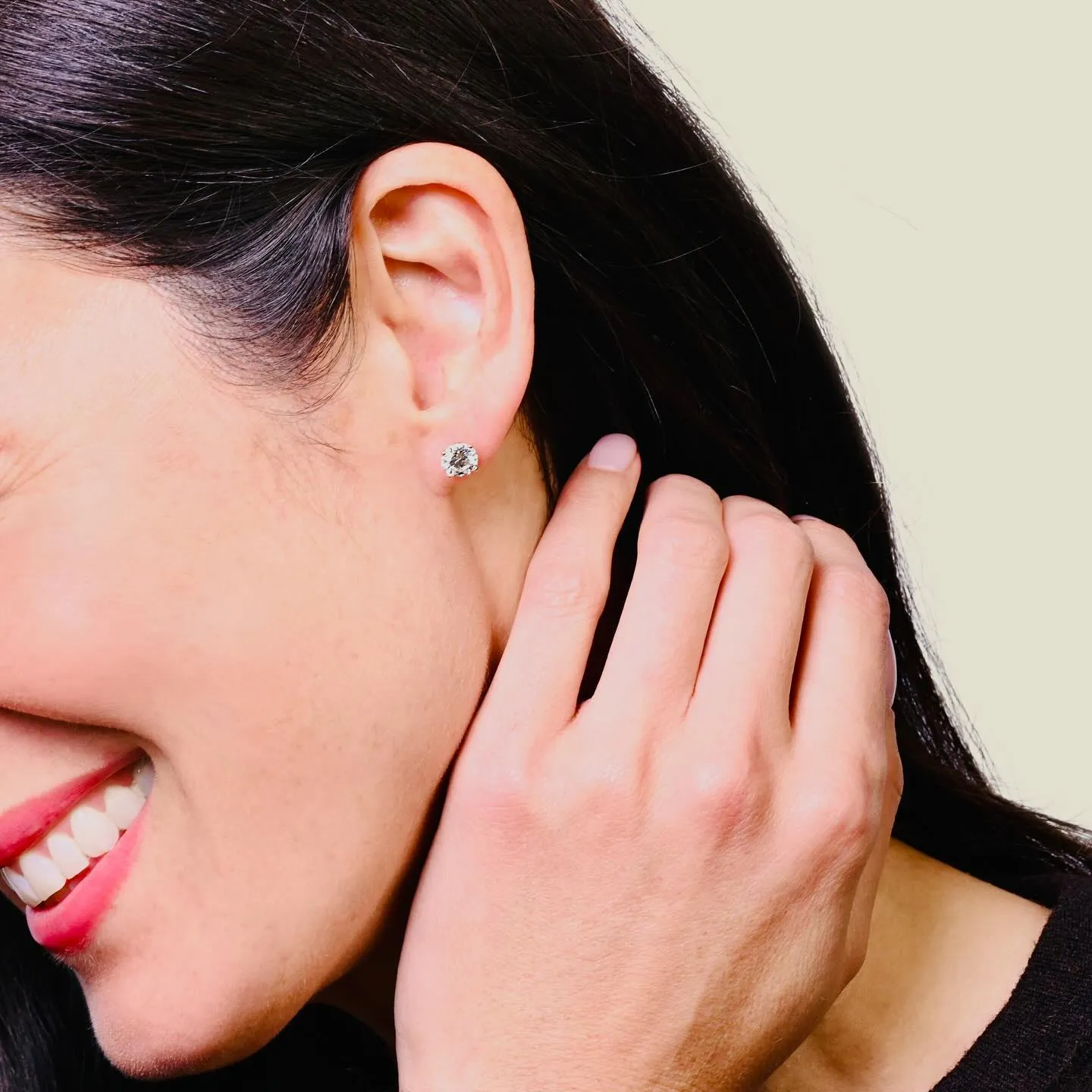 woman wearing a single diamond stud in the right ear. 