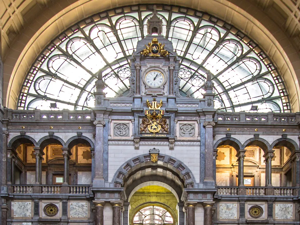 Antwerp's stunning train station interior with intricate architecture and a large glass dome.