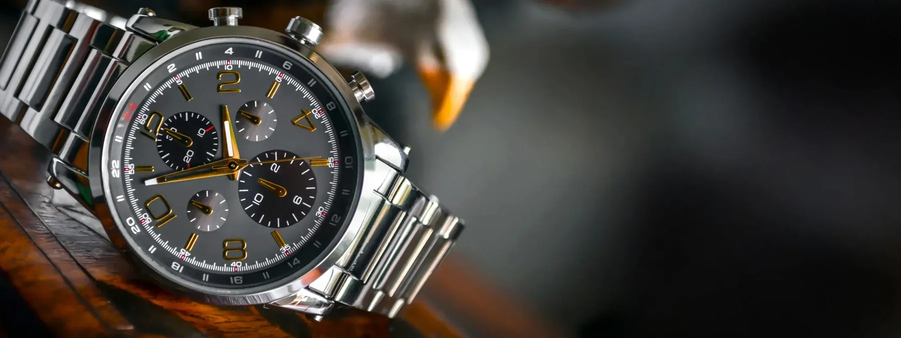 Stylish gray chronograph watch with gold accents and stainless steel band, featured at Michael & Son's Jewelers in Reno.