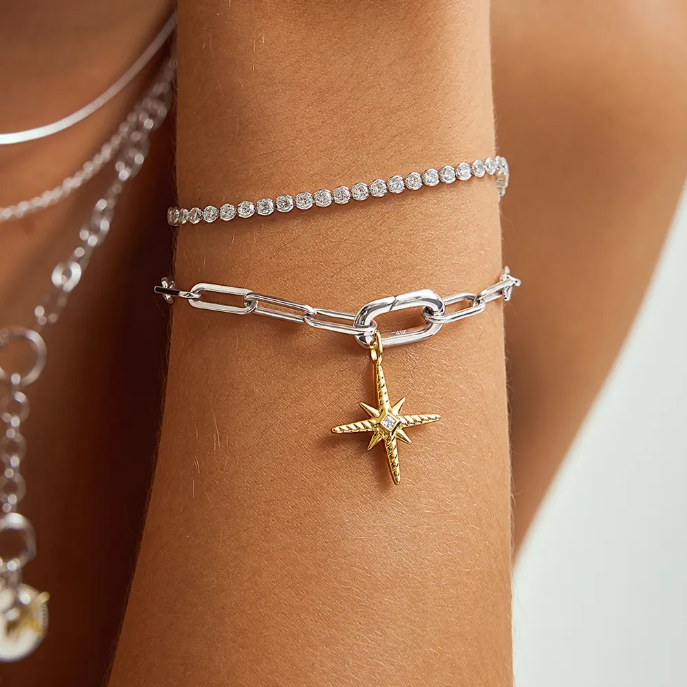 Close-up of a silver and gold bracelet with a star charm, showcasing elegant jewelry from Michael & Son's Jewelers in Reno.