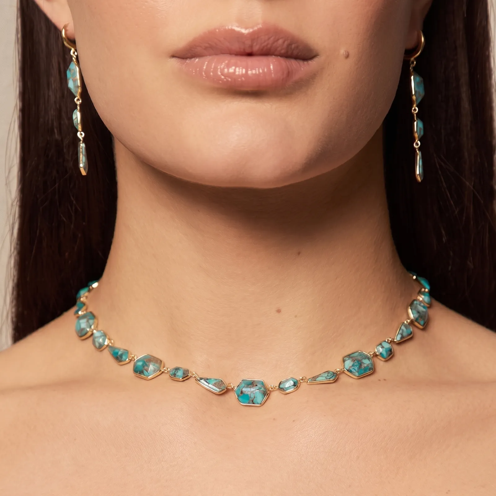 Turquoise gemstone necklace and earrings on a model. Shop now at Midtown Jewelers.