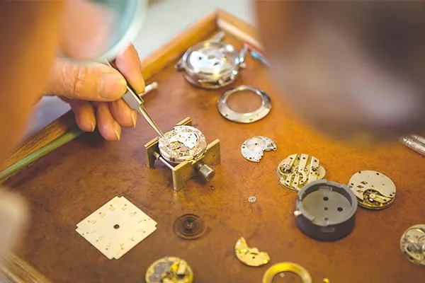 Master watchmaker performing precision watch repair at Midtown Jewelers