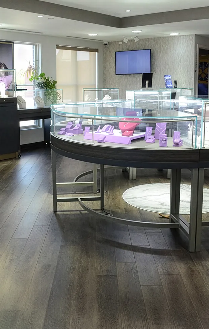Jewelry store interior with glass display cases and purple stands.