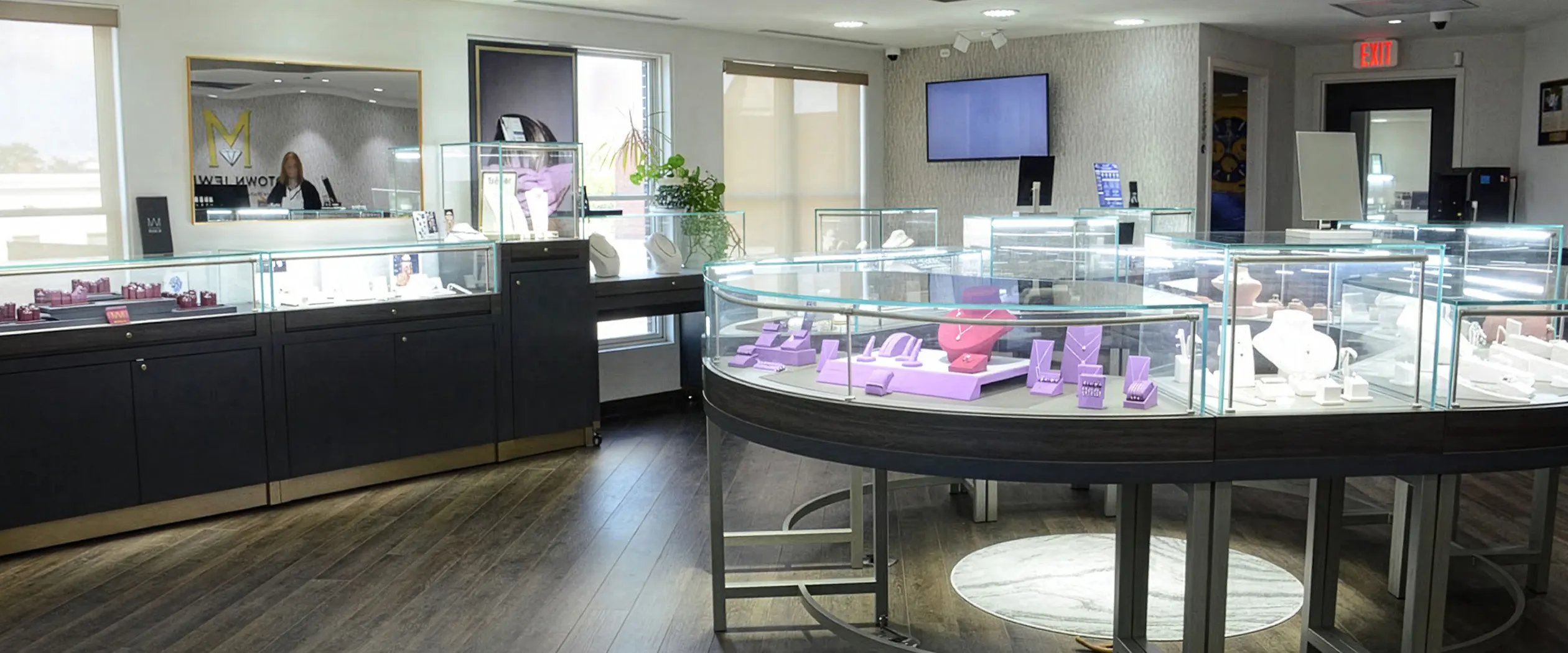 Jewelry store interior with glass display cases and purple stands.