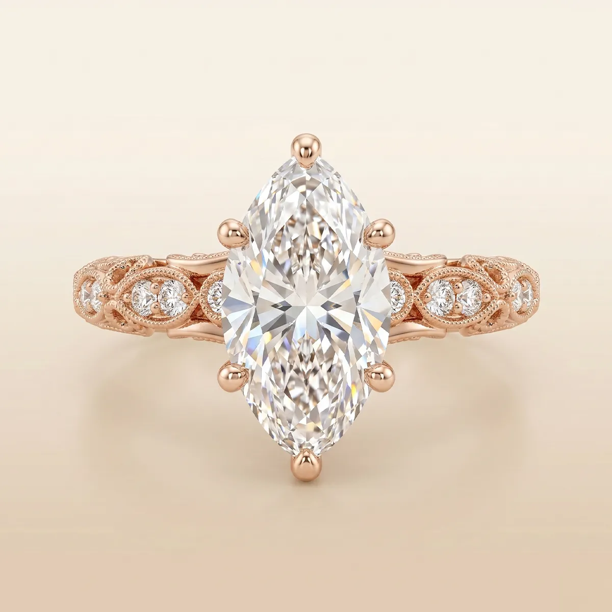 Marquise diamond ring with intricate rose gold band design.