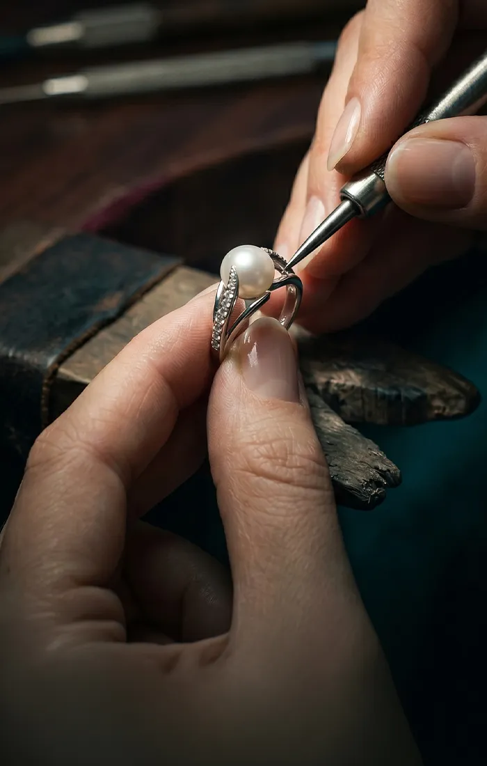 Jeweler working on a pearl ring at Midtown Jewelers in Herndon. Learn More.